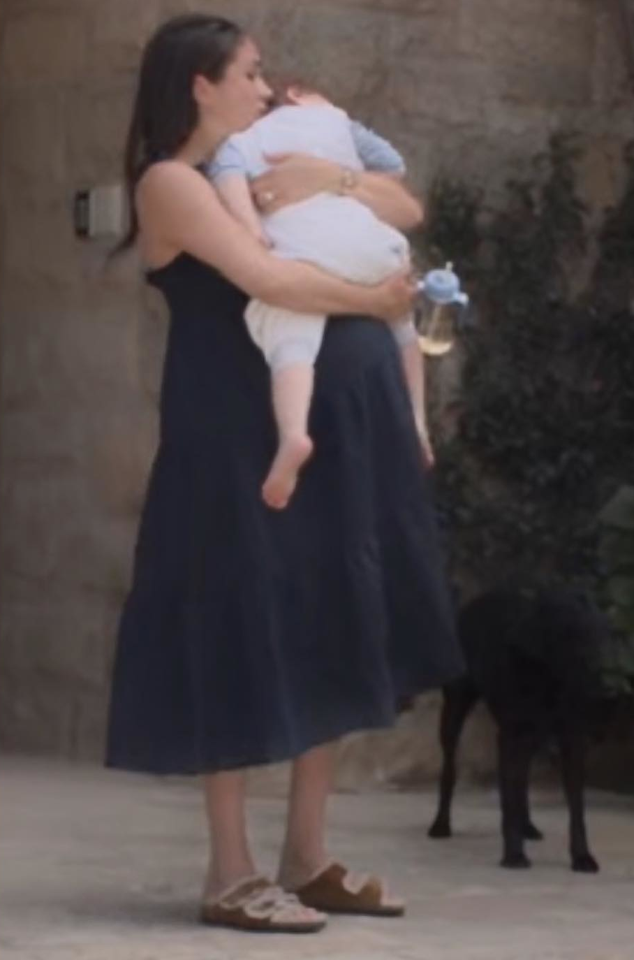 Meghan Markle wears navy blue J.Crew Tiered Ruffle Maxi Beach Dress in Crinkle Cotton and a pair of Birkenstock 'Arizona' Shearling-Lined Suede sandals in Tan