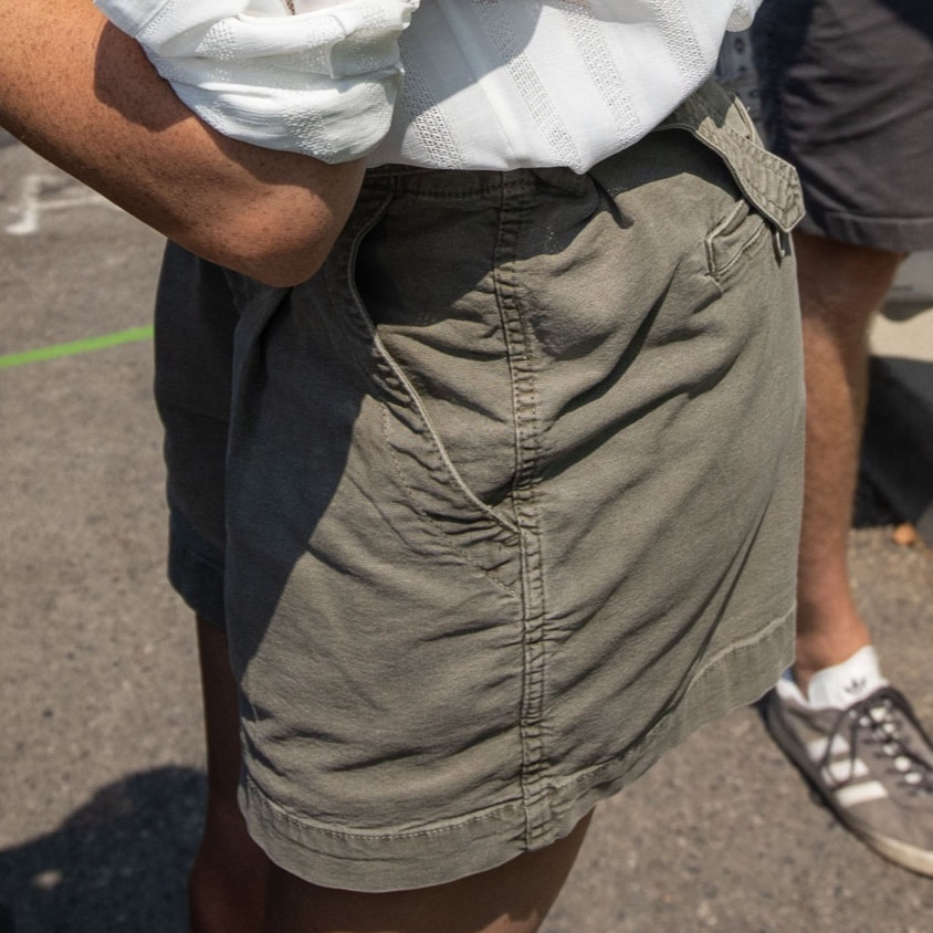 Meghan wears Khaki pleated-front shorts with belt