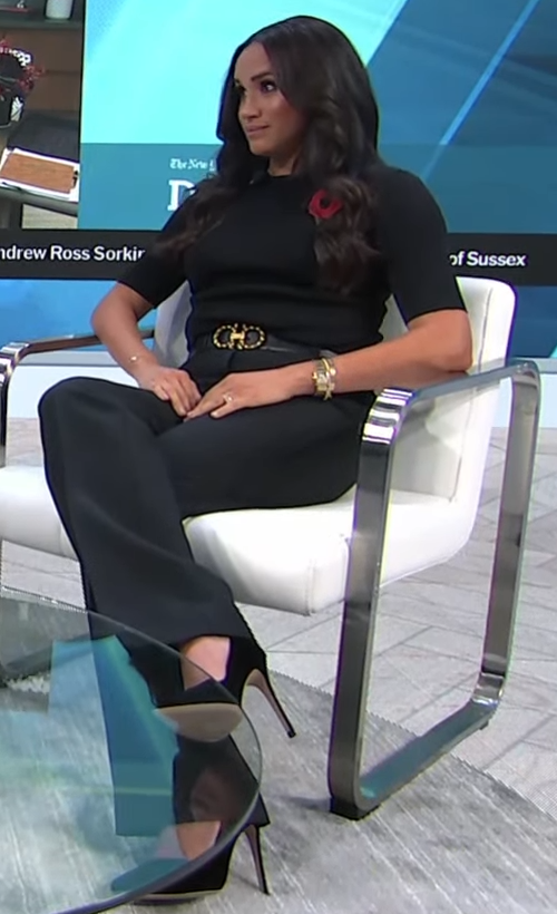 Meghan Markle wears Black short sleeve top and straight-leg trousers