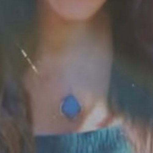 Meghan wore a pendant necklace featuring a large blue stone.